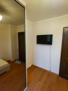 a room with a television on the wall and a mirror at Pozlovice225 in Pozlovice