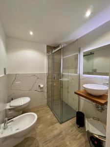 a bathroom with two sinks and a glass shower at Calumidda in Catania