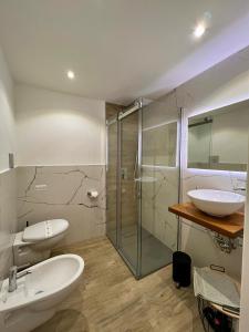 een badkamer met 2 wastafels en een glazen douche bij Calumidda in Catania