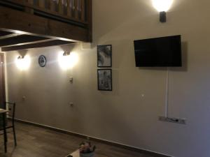 a living room with a flat screen tv on the wall at Green Olive Studios 2 in Agios Mamas