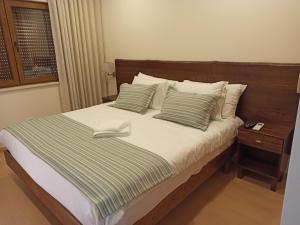 a bed with a pair of white shoes sitting on it at Fontanário House in Alpiarça