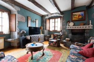 a living room with a couch and a fireplace at Arangiz Etxea in Aulestia