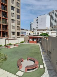 a large artificial lawn in a city with buildings at Departamento completo Surquillo/Miraflores in Lima