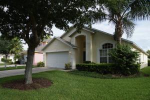 a white house with a tree in the yard at Grosvenor Villa TM148 in Davenport