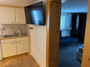 a small kitchen with a sink and a microwave at Ferienwohnung Jäger in Kappl