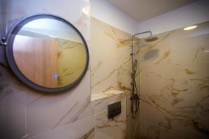 a bathroom with a mirror and a shower at Olea Garden Apartments in Stavros +38 photos