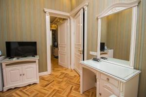 a room with a desk with a television and a mirror at Sanata in Tbilisi City