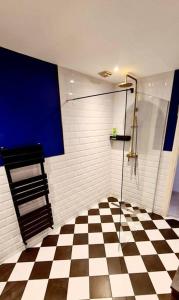 a bathroom with a shower and a checkered floor at Gorgeous 2 Bedroom Sanctuary in Kent