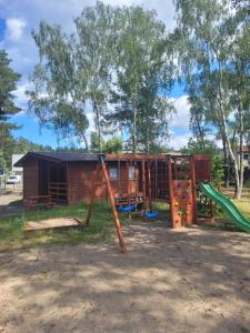 a playground with a slide and a play structure at FALA na WYSPIE in Sobieszewo