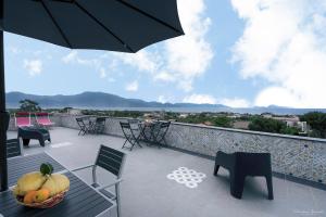 a balcony with a bowl of fruit on a table at Villa Vesuviana in Torre del Greco