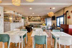 a restaurant with tables and chairs and a bar at La Fonda in Cadaqués