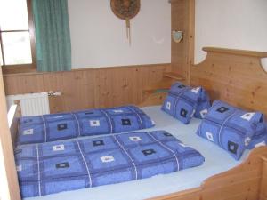 a bedroom with two blue pillows on a bed at Lampeterhof in Matrei in Osttirol