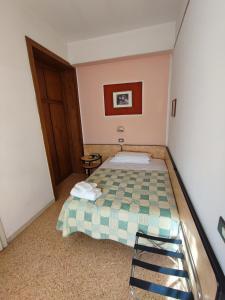 een kleine slaapkamer met een bed en een stoel bij Hotel Primavera sul mare in Lido di Savio