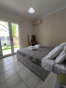 Postel nebo postele na pokoji v ubytování Konomi Residence-Marilena Apartment