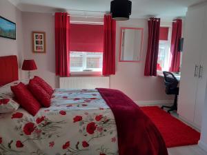 a bedroom with a bed with red curtains at Safe haven in Peacehaven