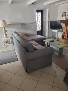 sala de estar con sofá y mesa en La Maison Colline en Luxé