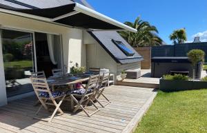 a patio with a table and chairs on a deck at Ty Gaï - Roscoff in Roscoff