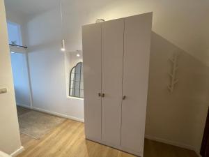a white cabinet in a room with a hallway at Apartments Lungo Mare in Sveti Stefan