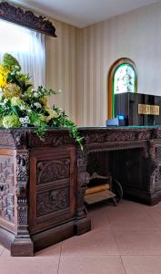 a wooden altar with plants on top of it at Hotel Sen in Świebodzin
