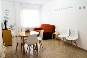 a living room with a table and chairs and a couch at APARTAMENTS ROIG in Benasal +20 photos