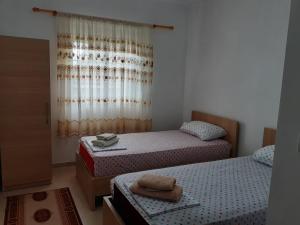 a bedroom with two beds and a window at Nesti Relax Home in Pogradec
