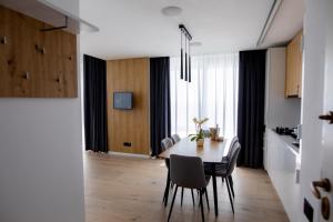 a kitchen and dining room with a table and chairs at Sea On Mamaia in Mamaia