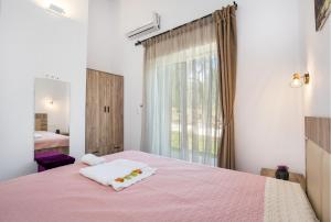 A bed or beds in a room at AVGOUSTIDIS APARTMENTS