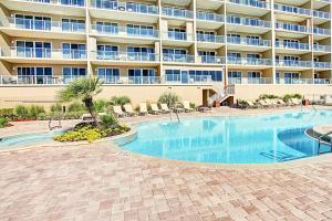 a swimming pool in front of a large apartment building at Sterling Sands 111 in Destin