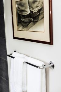 a picture hanging above a towel rack in a bathroom at The New Brunswick Bed and Breakfast in Saint Andrews