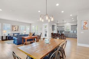 a dining room and living room with a wooden table at The Heidi-way in Destin