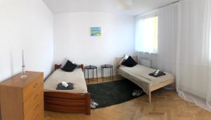 Pokój z 2 łóżkami, komodą i oknem w obiekcie Apartment Świętojerska w Warszawie