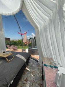 a bedroom with a canopy bed and a patio at Cupola glamping dome Sarajevo in Sarajevo