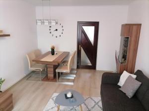 a living room with a couch and a dining room table at Joy Apartman in Sovata