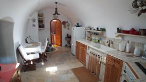 a kitchen with a white refrigerator and a table at Kytherian Traditional Home in Friligkianika