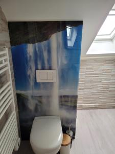 baño con aseo blanco y pared azul en Résidence Valissou, en Châteauroux