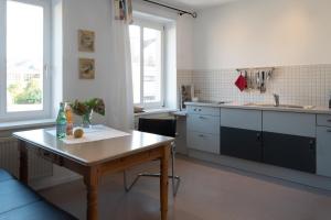 a kitchen with a table and a counter top at Gästehaus Stadtmitte in Merzig
