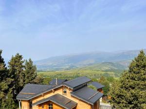 a house with solar panels on top of it at Studio LUPIN Eyne pied de pistes in Eyne