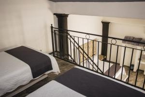 Postel nebo postele na pokoji v ubytování Hotel Nuevo Bernal