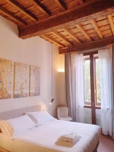 a bedroom with a white bed and a window at SPIRIT OF FLORENCE Boutique Rooms in Florence