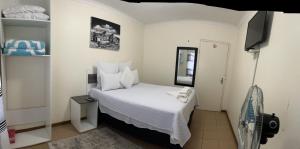 a small room with a bed and a television at Ncotshane BnB in Pongola +9 photos