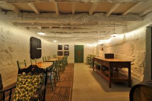 a room with tables and chairs and a green door at Quinta do Santinho in Amarante