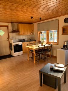 a kitchen and living room with a table and chairs at Villa Sus & Dus in Yngsjö