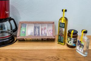 a wooden counter with a container and a bottle of honey at Malandris Studios in Skala Marion