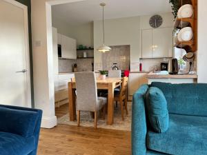 a kitchen and dining room with a table and chairs at Brecon View by Switchback Stays in Newport