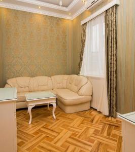 a living room with a couch and a table at Sanata in Tbilisi City