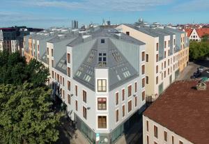 an overhead view of a white building with a gray roof at Spacious brand new modern apartment in Old Town in Rīga