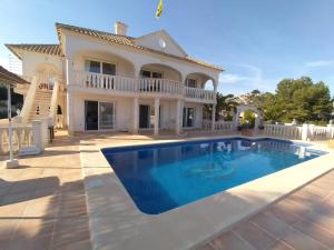 a villa with a swimming pool in front of a house at Casa Elite in Calpe +24 photos