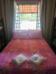 Tempat tidur dalam kamar di Pousada Recanto Dos Tucanos