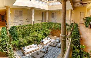 een binnentuin met witte banken en planten bij Hotel Casa Canabal by Faranda Boutique in Cartagena