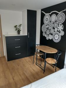 a room with a table and chairs and a cabinet at Całoroczne Leniuchowo in Ponizie